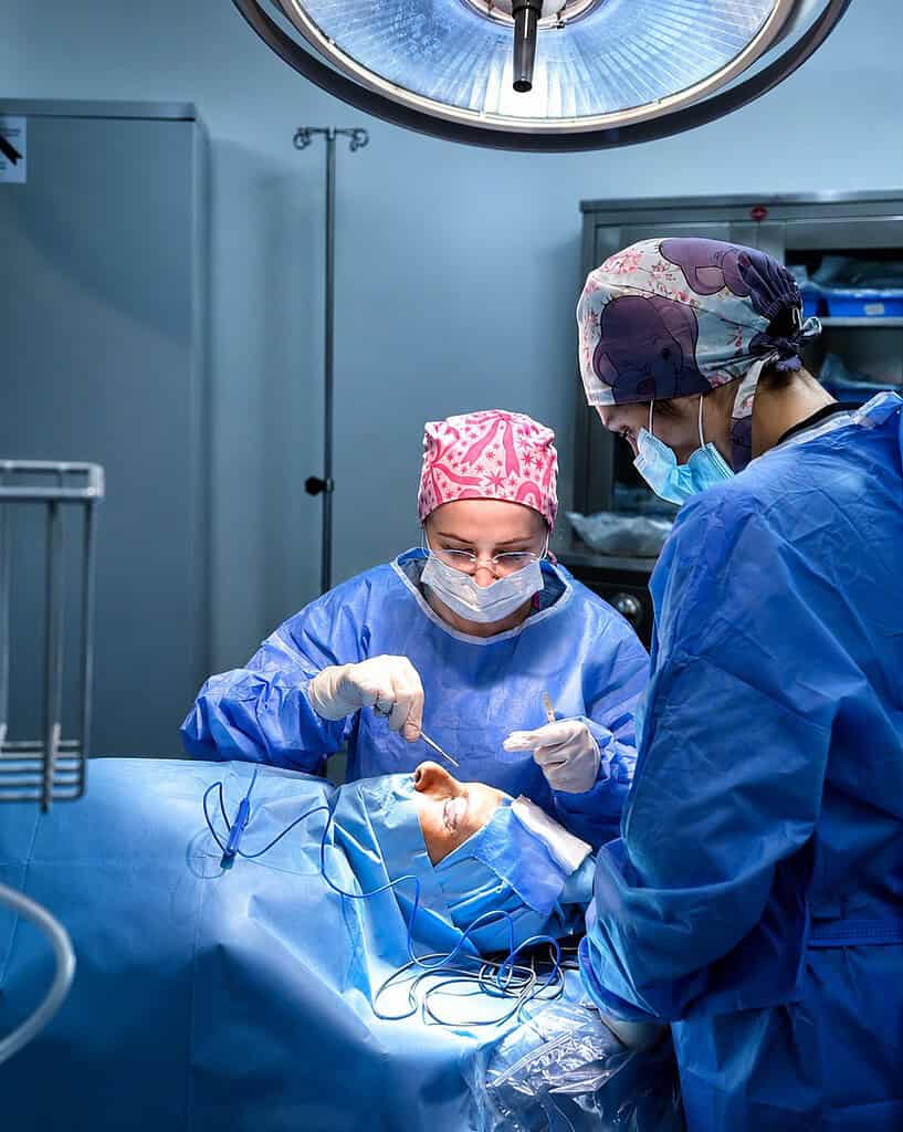 Procedimiento de cirugía plástica en Albania con equipo médico en el quirófano.